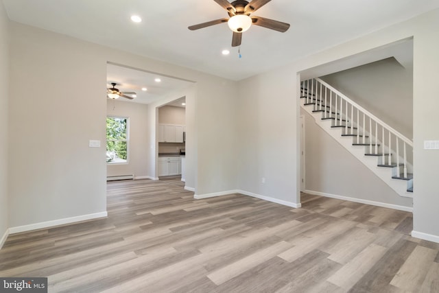 407 Lingle St, Osceola Mills, PA 16666 - unfurnished living room featuring ceiling fan, stairs, light wood-style flooring, recessed lighting, and baseboard heating