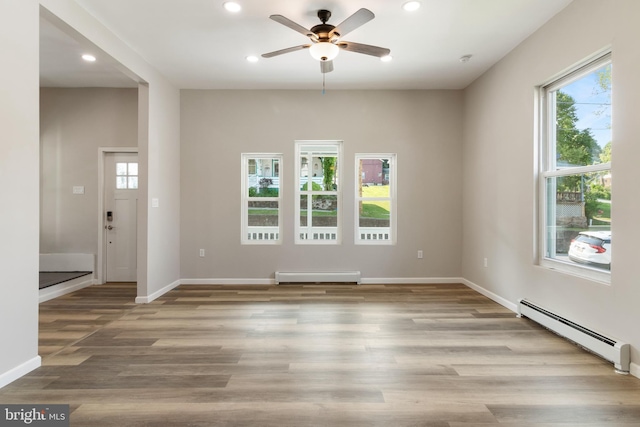 407 Lingle St, Osceola Mills, PA 16666 - unfurnished room with baseboard heating, a baseboard heating unit, ceiling fan, recessed lighting, and wood finished floors