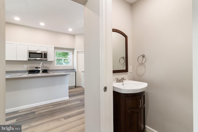 407 Lingle St, Osceola Mills, PA 16666 - bathroom with wood finished floors, vanity, and recessed lighting