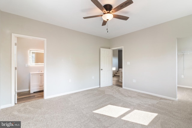 407 Lingle St, Osceola Mills, PA 16666 - unfurnished bedroom featuring carpet floors, a walk in closet, ensuite bathroom, a closet, and ceiling fan