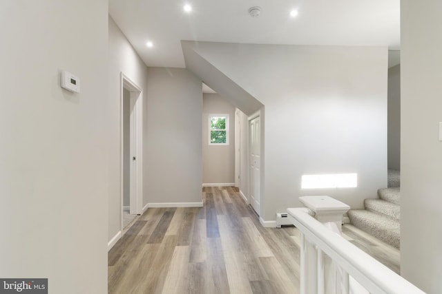407 Lingle St, Osceola Mills, PA 16666 - corridor featuring light wood-type flooring, a baseboard heating unit, recessed lighting, and stairs
