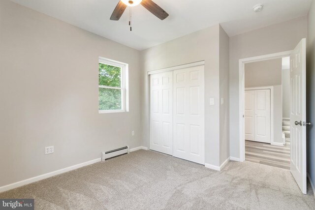 407 Lingle St, Osceola Mills, PA 16666 - unfurnished bedroom featuring a baseboard radiator, carpet, a closet, and ceiling fan