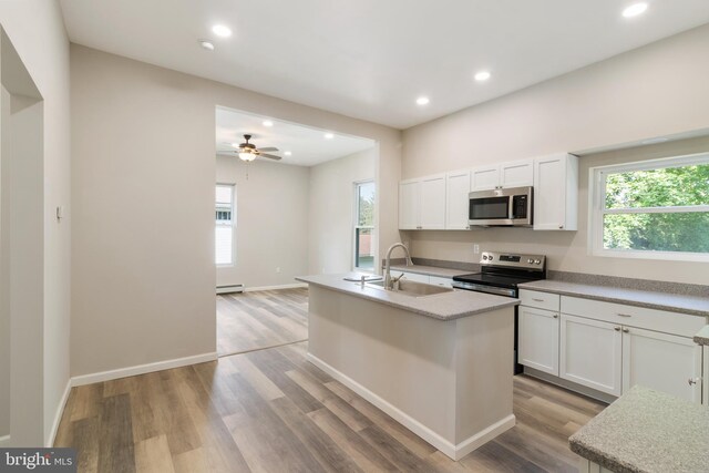 407 Lingle St, Osceola Mills, PA 16666 - kitchen featuring stainless steel appliances, light wood-style flooring, plenty of natural light, white cabinets, and recessed lighting