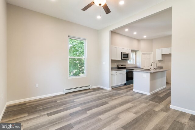 407 Lingle St, Osceola Mills, PA 16666 - kitchen with appliances with stainless steel finishes, baseboard heating, light wood-style floors, recessed lighting, and a ceiling fan