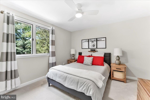 carpeted bedroom featuring baseboards and a ceiling fan