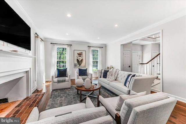 living area with crown molding, recessed lighting, baseboards, wood finished floors, and a fireplace with flush hearth