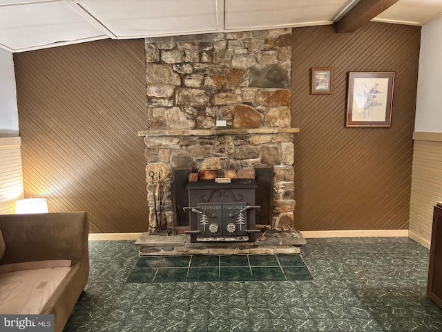 5580 Back Hollow Rd, Blain, PA 17006 - detailed view of a wood stove, tile patterned floors, wood walls, and baseboards
