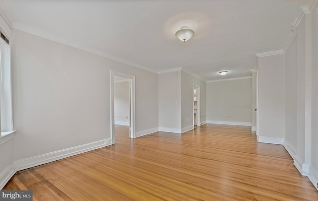 unfurnished room with light wood-style floors, baseboards, and crown molding