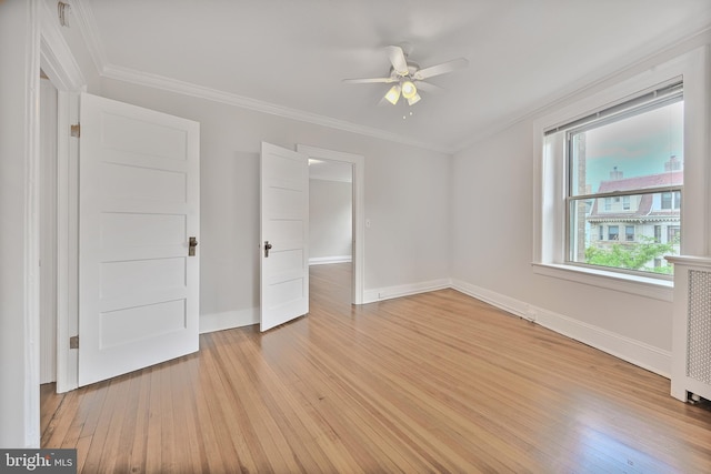 unfurnished bedroom with light wood finished floors, baseboards, crown molding, and a ceiling fan
