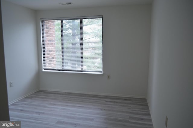 18050 Chalet Dr Unit 14-303, Germantown, MD 20874 - spare room featuring plenty of natural light, wood finished floors, and baseboards
