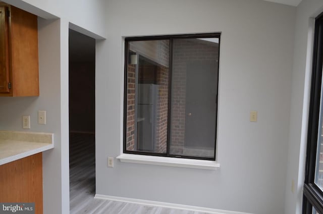 18050 Chalet Dr Unit 14-303, Germantown, MD 20874 - unfurnished dining area with light wood-type flooring and baseboards