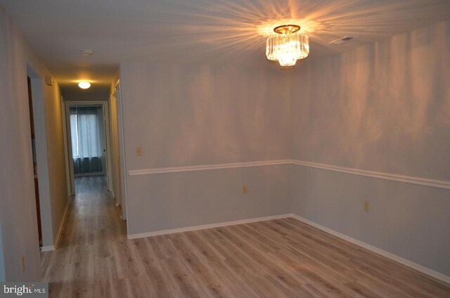 18050 Chalet Dr Unit 14-303, Germantown, MD 20874 - empty room with light wood-type flooring, a chandelier, and baseboards