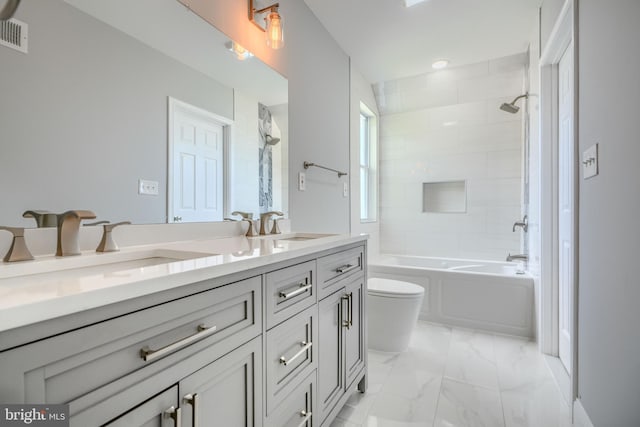 4106 Fleetwood Ave, Baltimore, MD 21206 - bathroom featuring toilet, double vanity, bathing tub / shower combination, and marble finish flooring