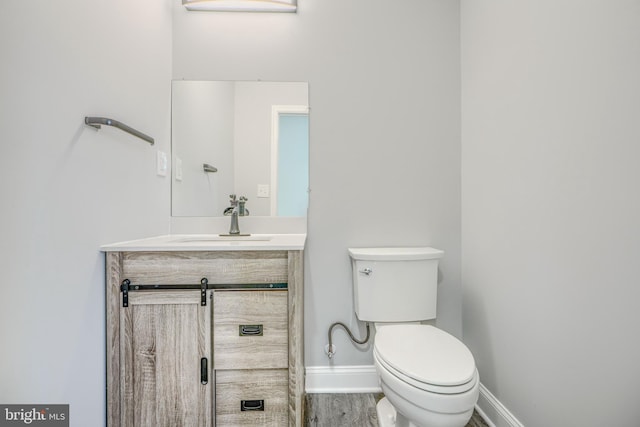 4106 Fleetwood Ave, Baltimore, MD 21206 - half bathroom with toilet, baseboards, vanity, and wood finished floors