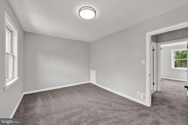 carpeted spare room with baseboards
