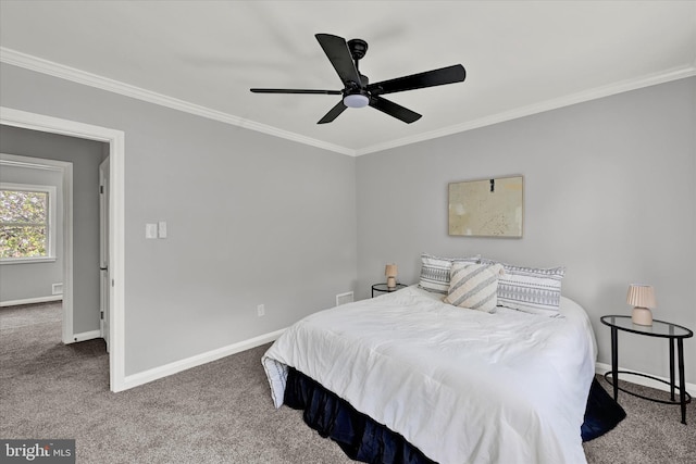 bedroom with carpet flooring, ornamental molding, baseboards, and a ceiling fan
