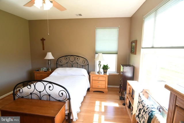 bedroom featuring light wood-style floors, baseboards, and ceiling fan