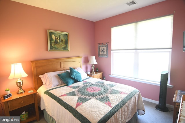 carpeted bedroom with multiple windows and baseboards