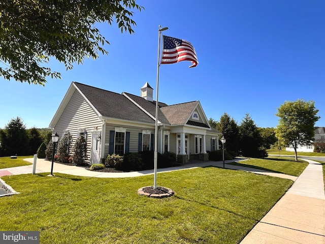 view of property exterior with a lawn and roof with shingles