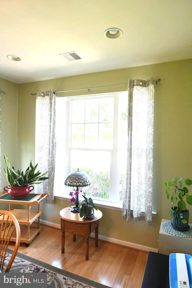 sitting room featuring wood-type flooring, baseboards, and recessed lighting