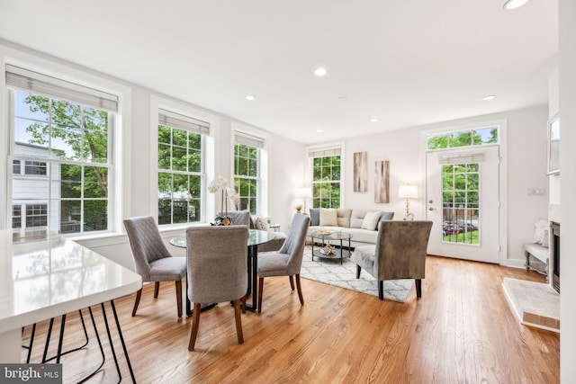 dining room with plenty of natural light, light wood-style flooring, recessed lighting, and baseboards