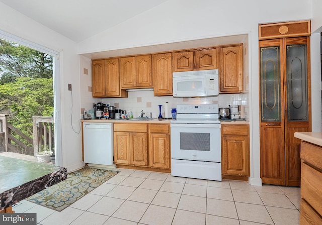 818 Aylesbury Garth, Arnold, MD 21012 - kitchen featuring white appliances, vaulted ceiling, light countertops, a sink, and backsplash