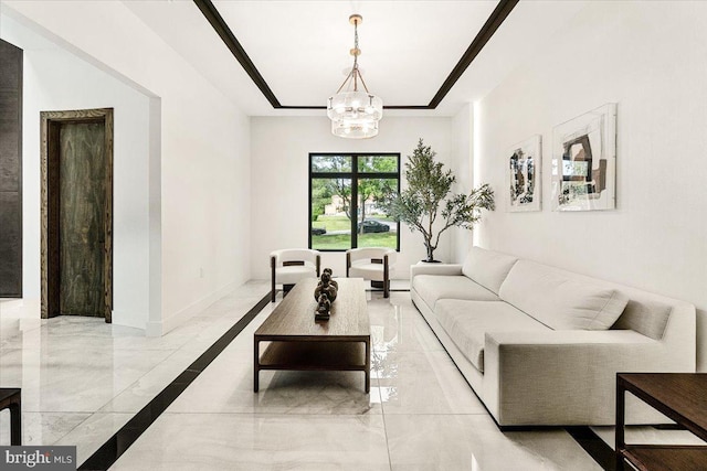 living area with light marble finish flooring, a chandelier, and baseboards
