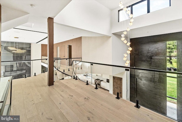 interior space featuring wood-type flooring and a towering ceiling