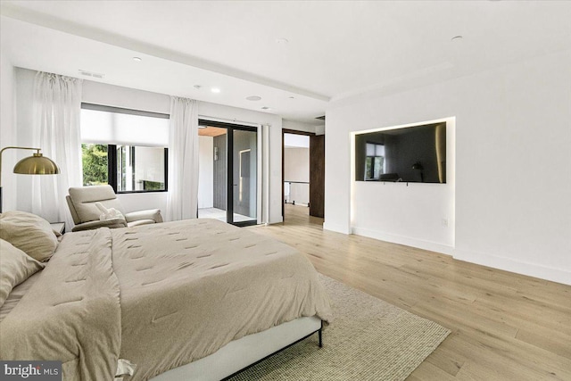 bedroom with wood finished floors, baseboards, access to exterior, and recessed lighting