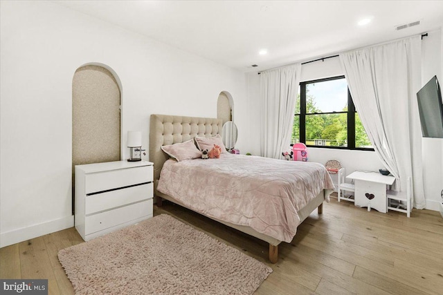 bedroom featuring hardwood / wood-style floors, recessed lighting, and baseboards