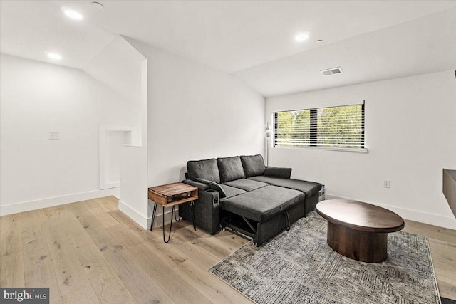 living area with light wood-style flooring, baseboards, lofted ceiling, and recessed lighting