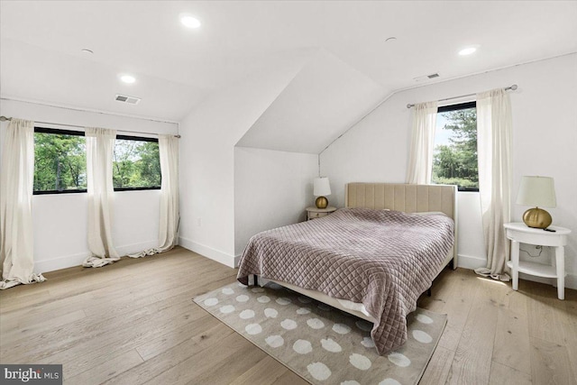 bedroom with multiple windows, light wood-type flooring, baseboards, lofted ceiling, and recessed lighting