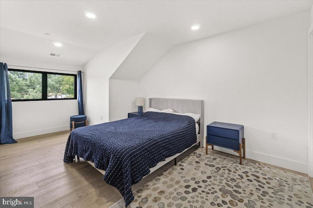 bedroom with lofted ceiling, baseboards, wood finished floors, and recessed lighting