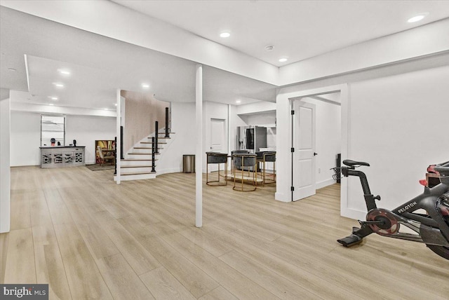 exercise room featuring light wood-type flooring and recessed lighting
