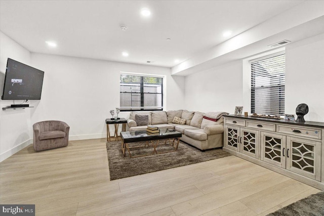 living room with light wood-type flooring, recessed lighting, and baseboards