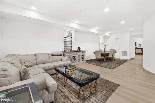 living room featuring wood finished floors, recessed lighting, and baseboards