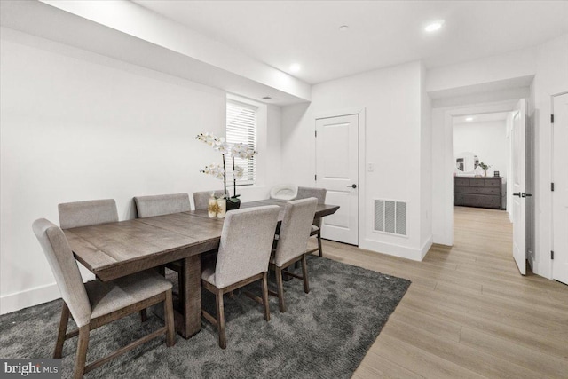 dining area featuring light wood-style flooring, recessed lighting, and baseboards
