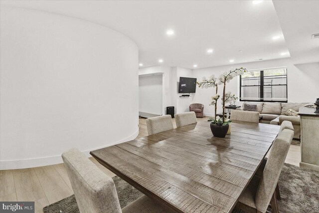 dining space featuring recessed lighting and wood finished floors