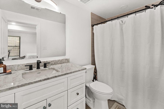ensuite bathroom with toilet and vanity