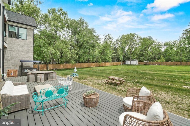 deck with a shed, an outbuilding, and view of scattered trees