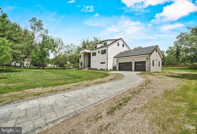 view of home's exterior with an attached garage, decorative driveway, and a yard