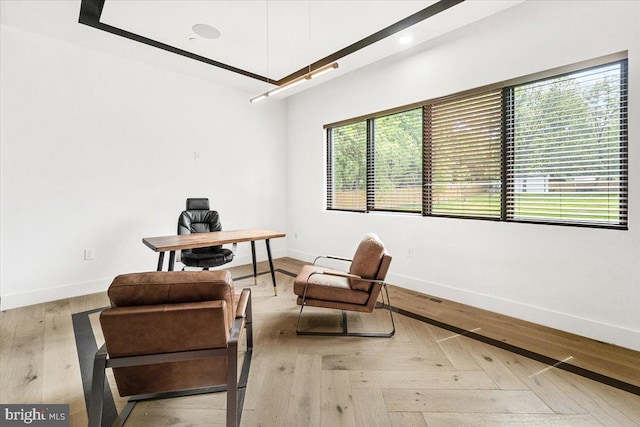 office space with baseboards and wood finished floors