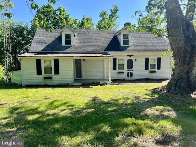 view of front of property featuring a front yard and a chimney