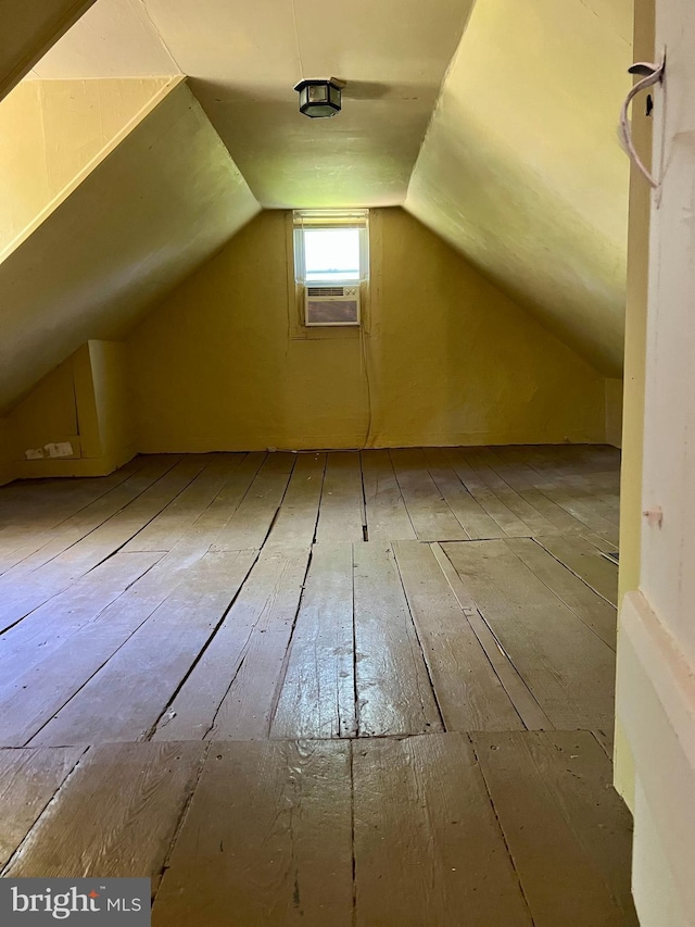 bonus room featuring vaulted ceiling and hardwood / wood-style floors