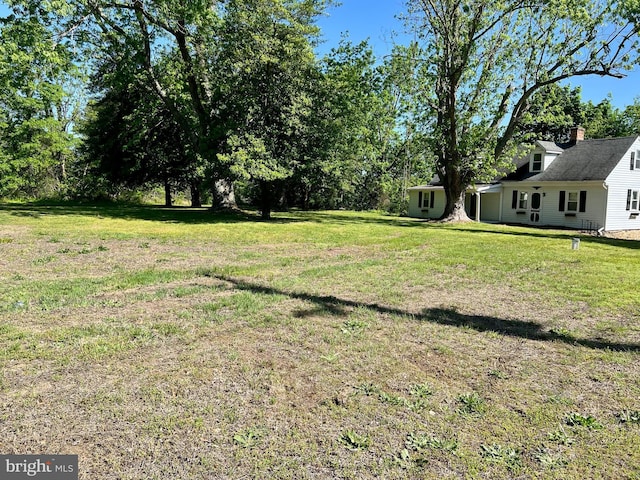 view of grassy yard featuring view of scattered trees