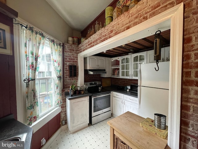 120 Hanover St, Pemberton, NJ 08068 - kitchen with stainless steel range with electric cooktop, freestanding refrigerator, healthy amount of natural light, under cabinet range hood, and brick wall