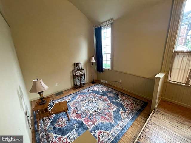 120 Hanover St, Pemberton, NJ 08068 - bedroom with wood-type flooring, multiple windows, a wainscoted wall, and vaulted ceiling