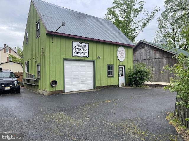 120 Hanover St, Pemberton, NJ 08068 - garage with asphalt driveway and a garage