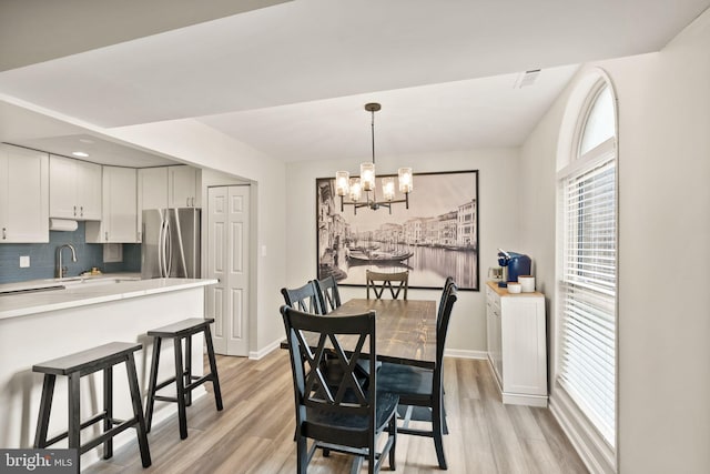 7 Canterbury Sq Unit 401, Alexandria, VA 22304 - dining room with a chandelier, light wood-style flooring, and baseboards