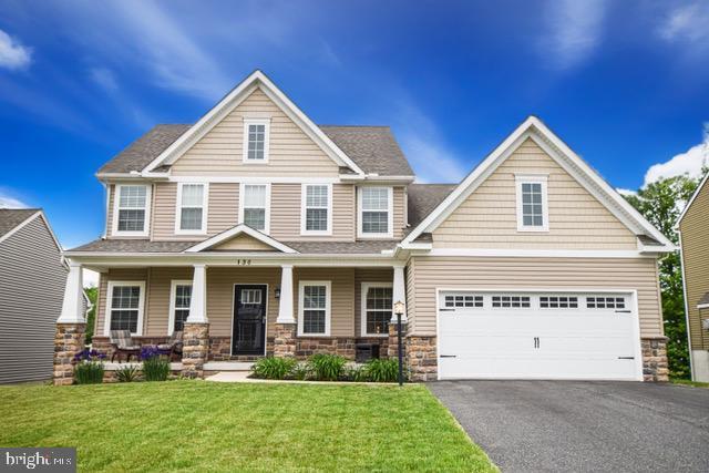 130 Steamboat Ct, North East, MD 21901 - craftsman-style house with asphalt driveway, a porch, a garage, and stone siding